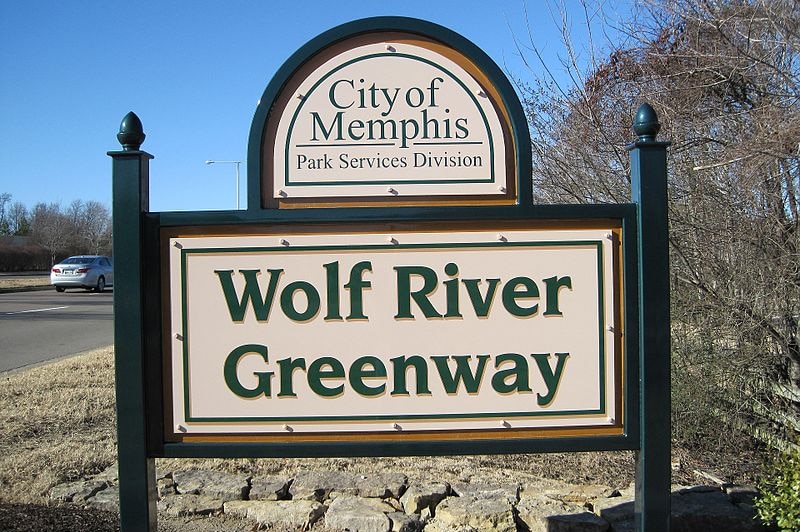 A sign that reads "Wolf River Greenway" in the city of Memphis, Tennessee, in the United States.