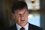 Angus Taylor looks toward the camera.