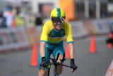 Cyclist Cameron Meyer smiles on his bike after winning time trial
