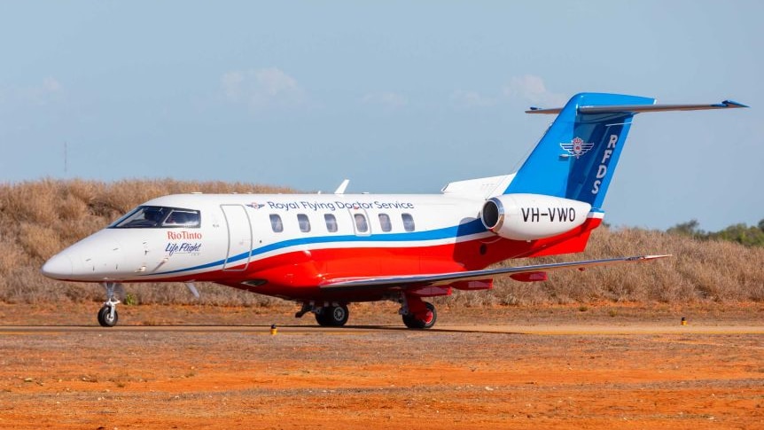 Royal Flying Doctor Service jet on dirt airstrip.