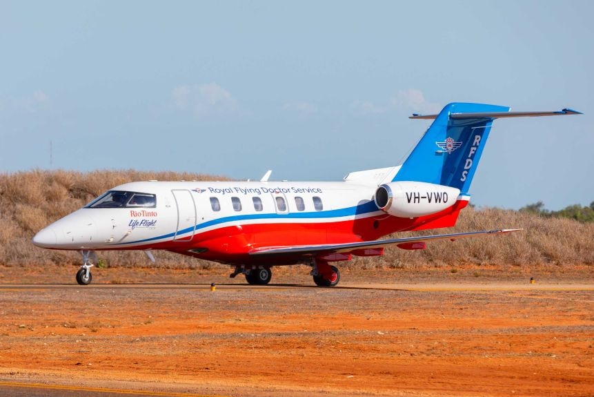 Royal Flying Doctor Service jet on dirt airstrip.