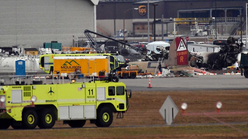 Emergency crews respond to the burning ruins of a plane crash in Connecticut