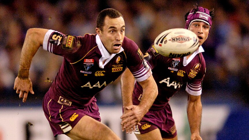 Adam Mogg has his eyes on the ball as Johnathan Thurston looks on