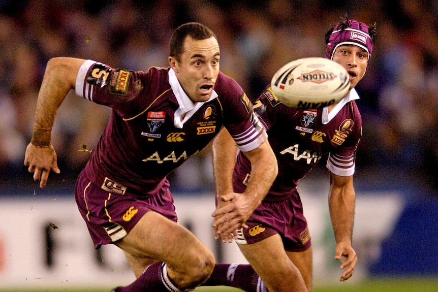 Adam Mogg has his eyes on the ball as Johnathan Thurston looks on