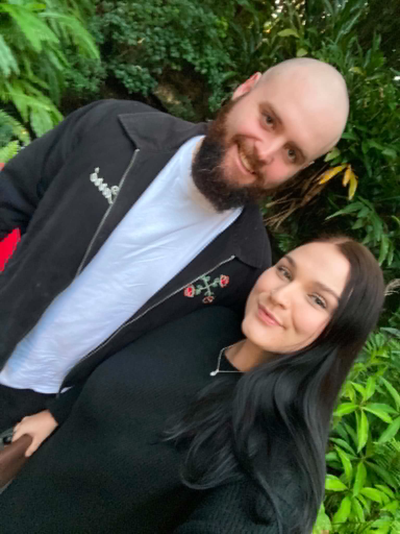 A young couple smiling at the camera