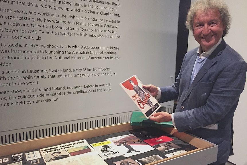 Paddy MacDonald, to right of image, holds up a Charlie Chaplin picture board.