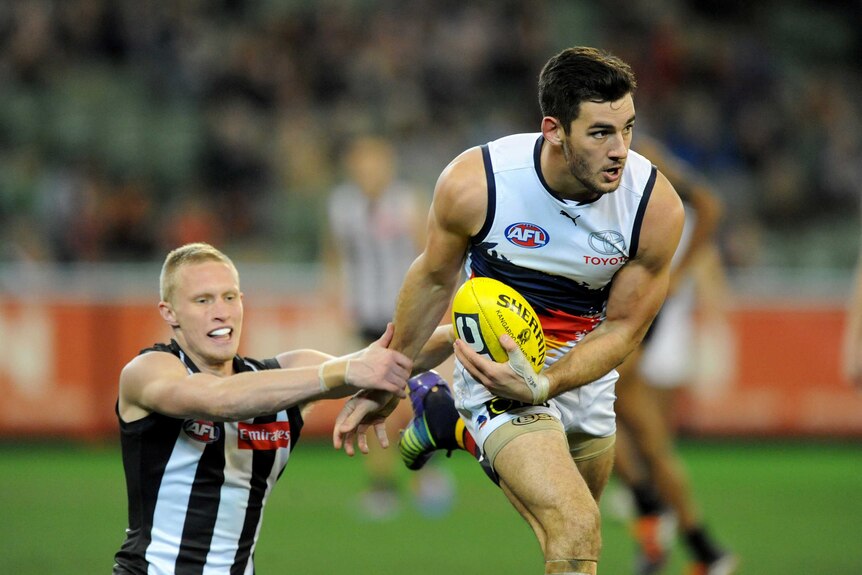 The Crows' Taylor Walker marks ahead of Collingwood's Jack Frost at the MCG.