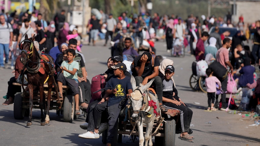 Palestinians flee to the southern Gaza Strip along Salah al-Din Street in Bureij, Gaza Strip, Thursday, Nov. 9, 2023. 