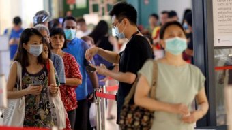 People in Singapore wear masks.