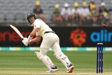 Marnus Labuschagne looks back over his shoulder as he leans forward for a run