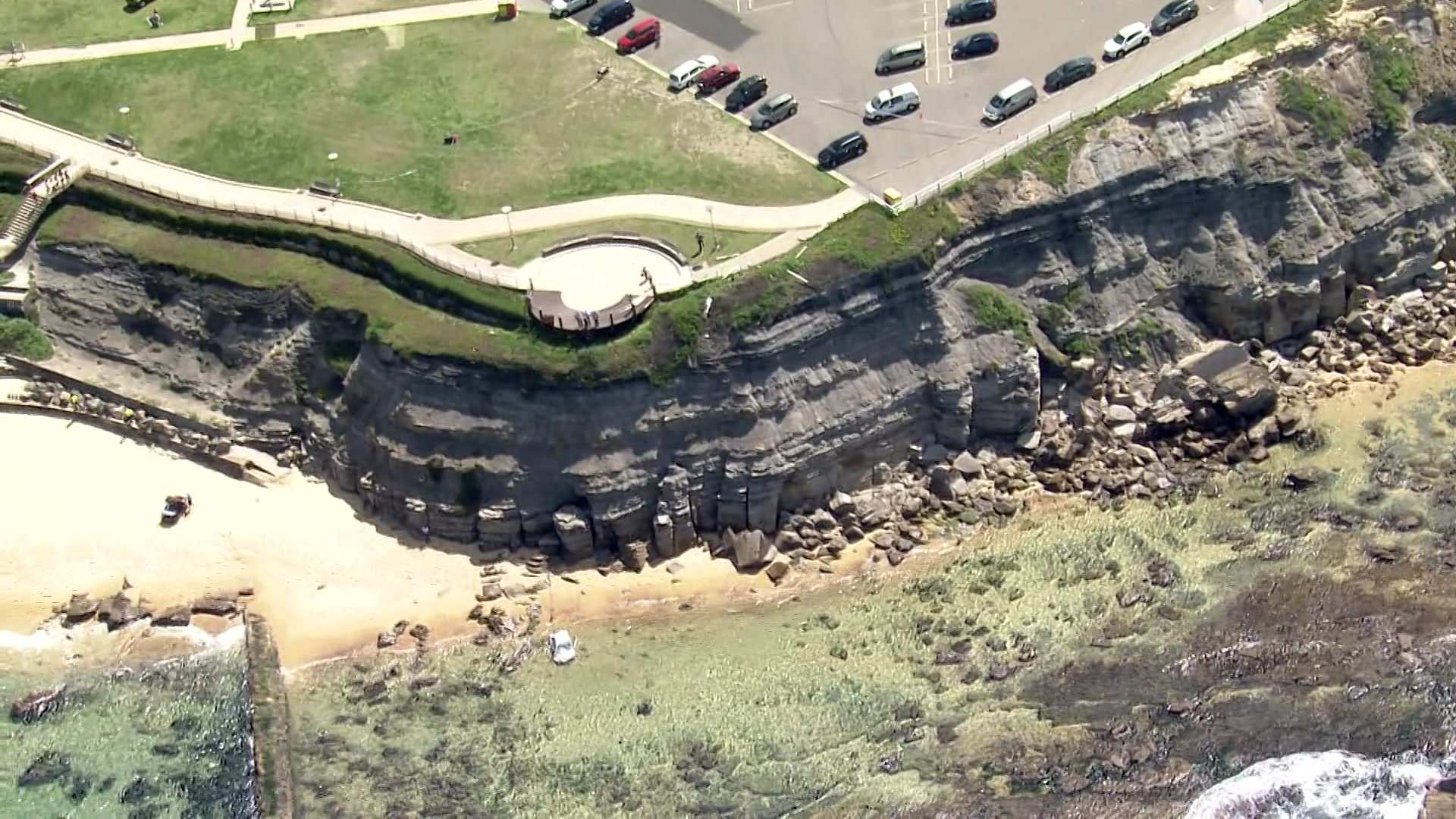 Woman charged after mother and baby injured when car drives over Bar Beach cliff at Newcastle