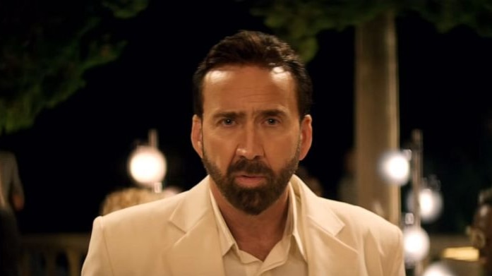 Nic Cage staring in a white suit