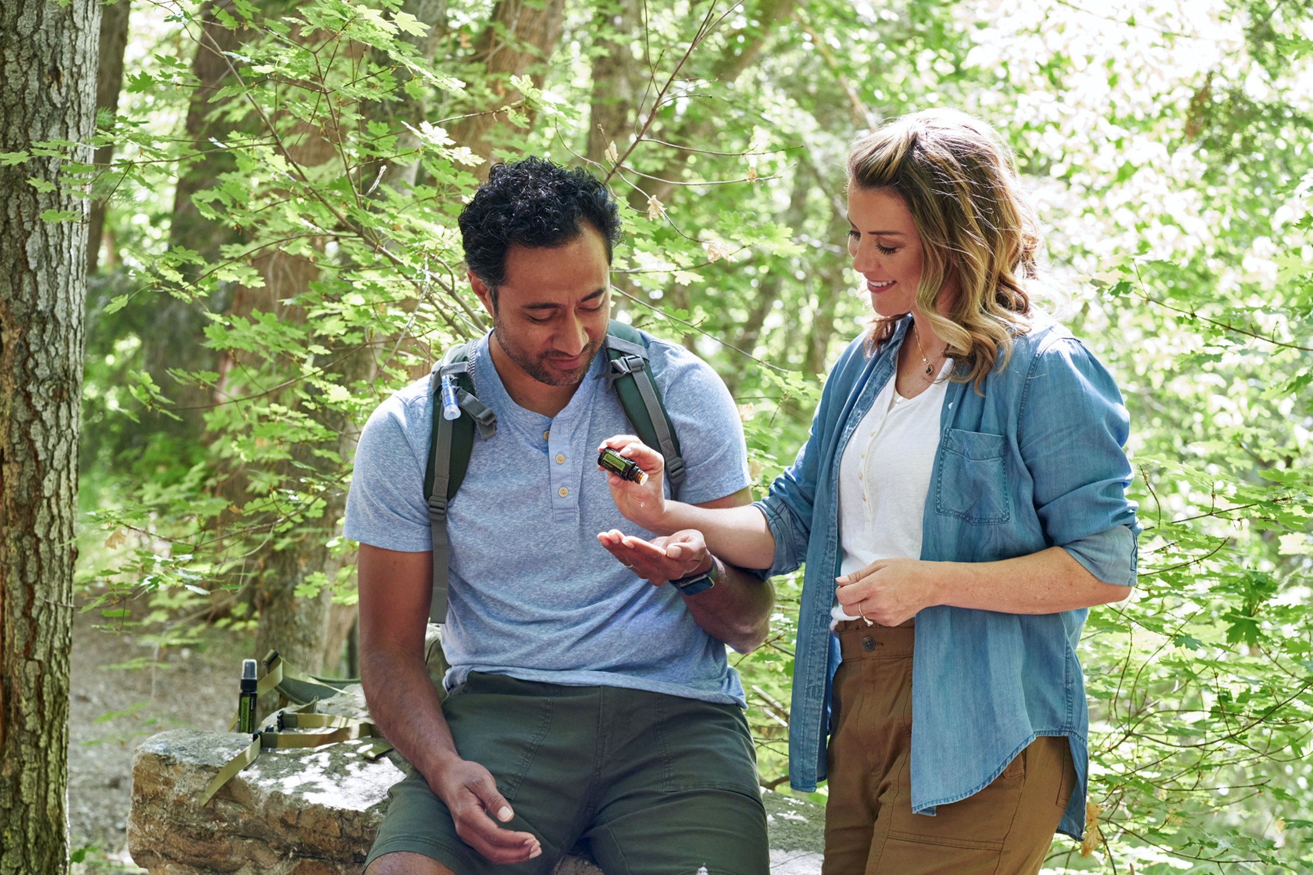Mosquito spray couple in the forest