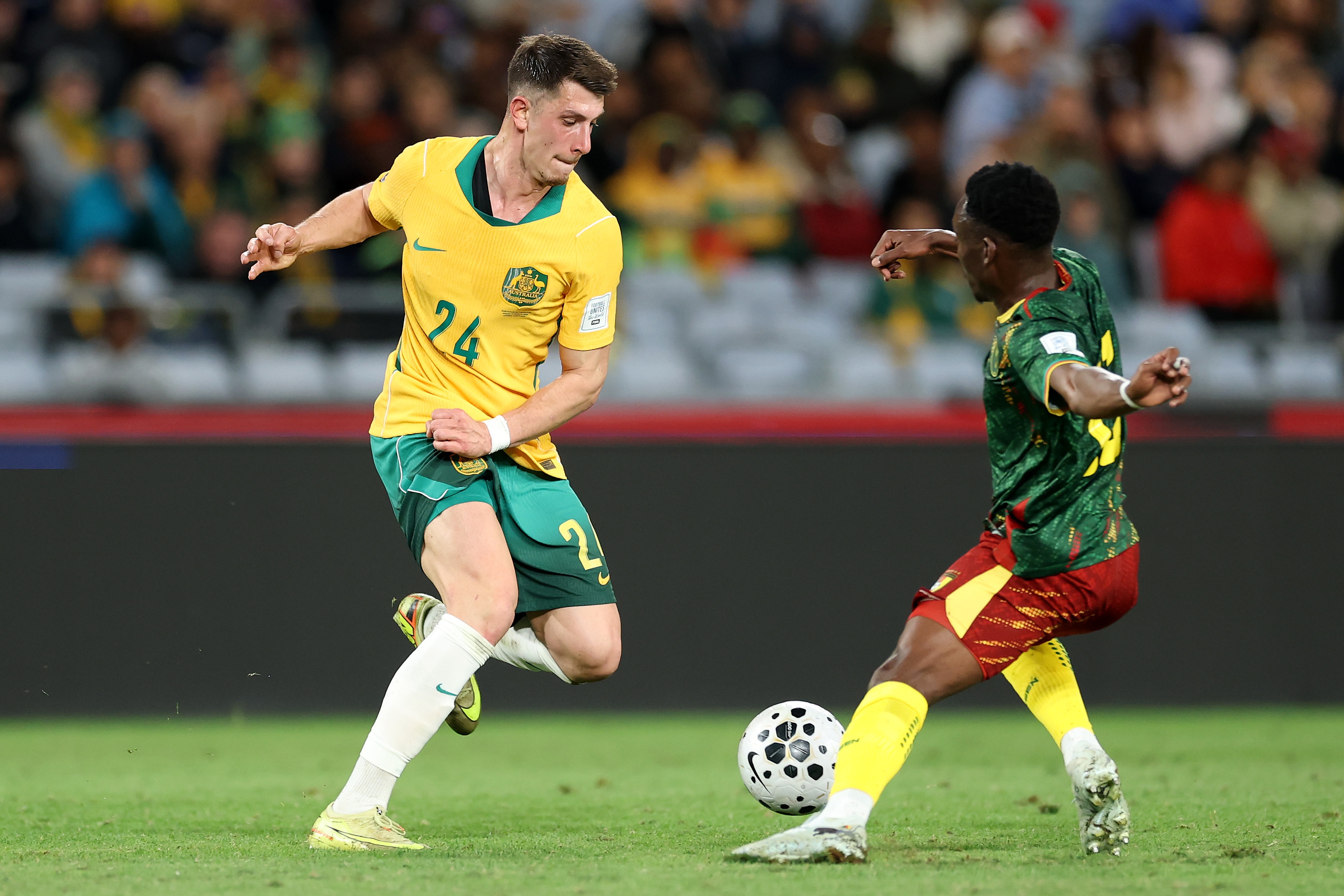 Socceroos striker Deni Juric is running towards the ball during a game