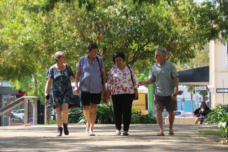 Former Timor-Leste pro-independence activists walk through Raintree Park in Darwin where they protested 20 years ago.