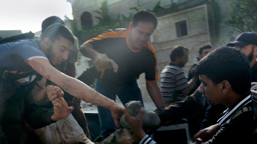 Men fight to save a man injured on one of Syria's deadliest days