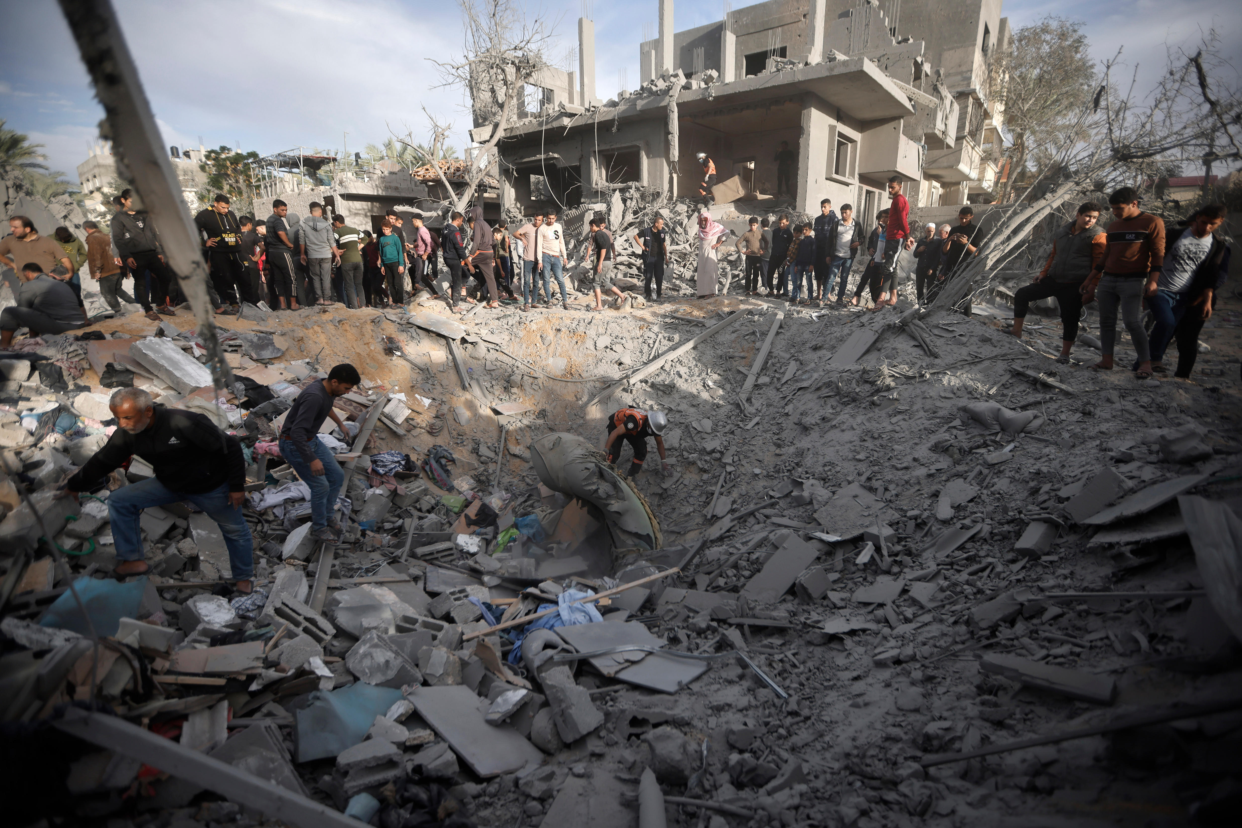 lots of people inspect rubble 