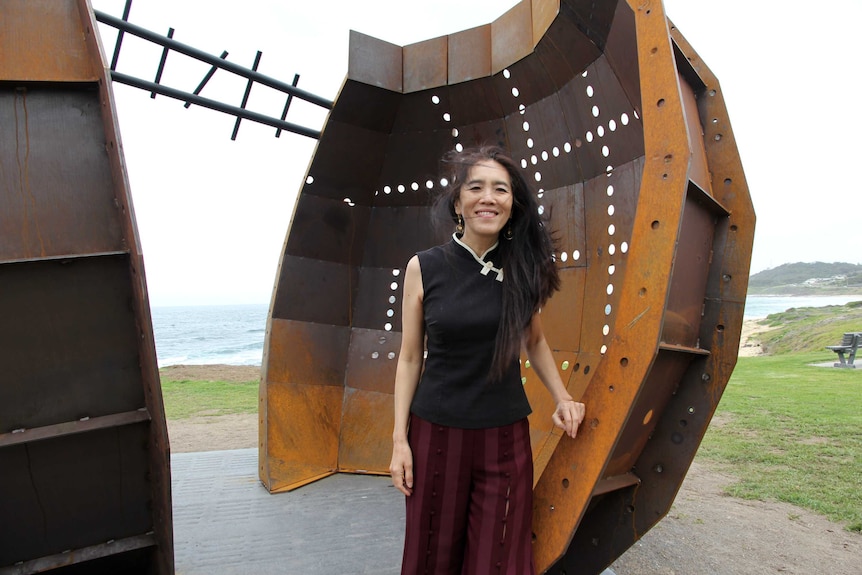 Tianli Zu stands with her monument of the Dalfram Dispute