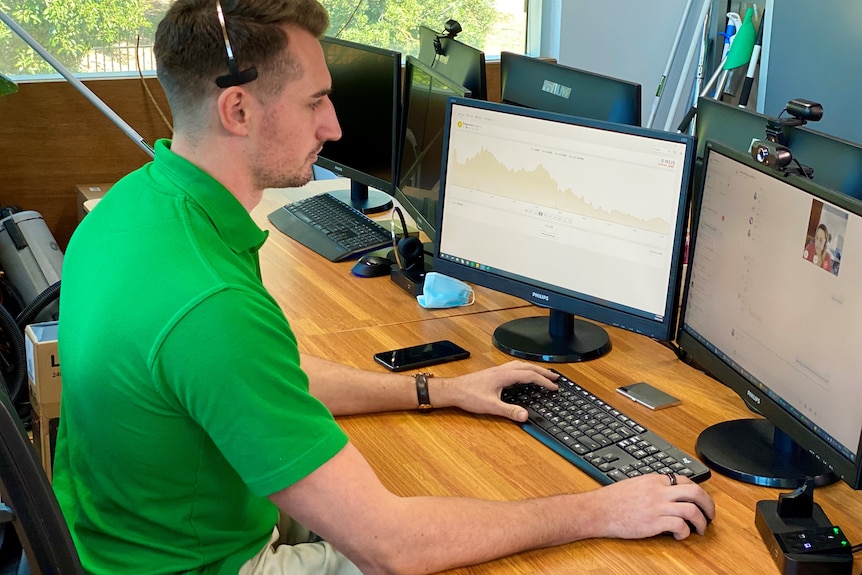 a man in a green shirt in an office