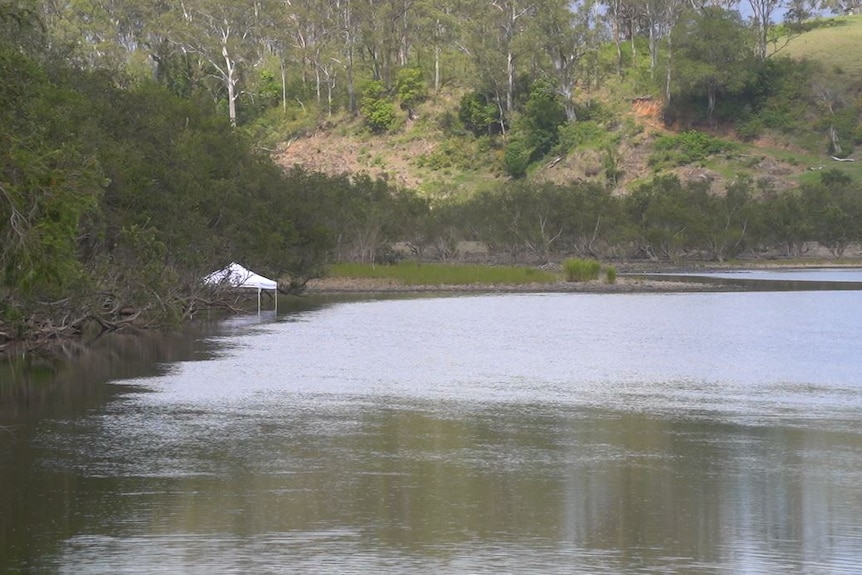 An emergency response marquee at the edge of a body of water