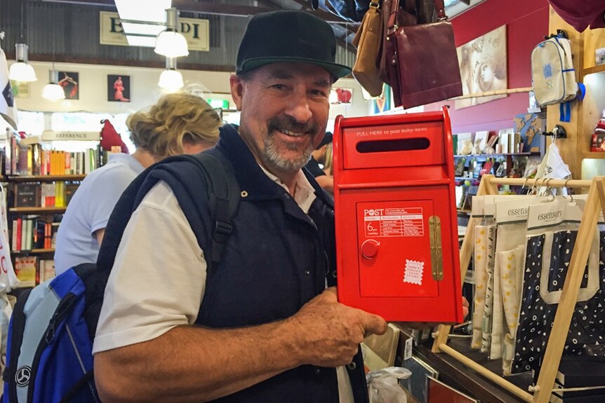 Collector Steve Powell holds a red post office box.