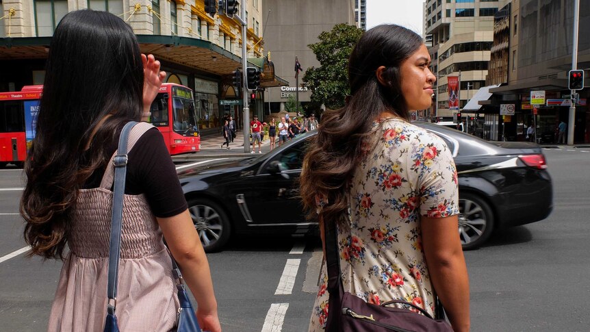 Mormon Sisters standing at traffic lights in Sydney CBD.