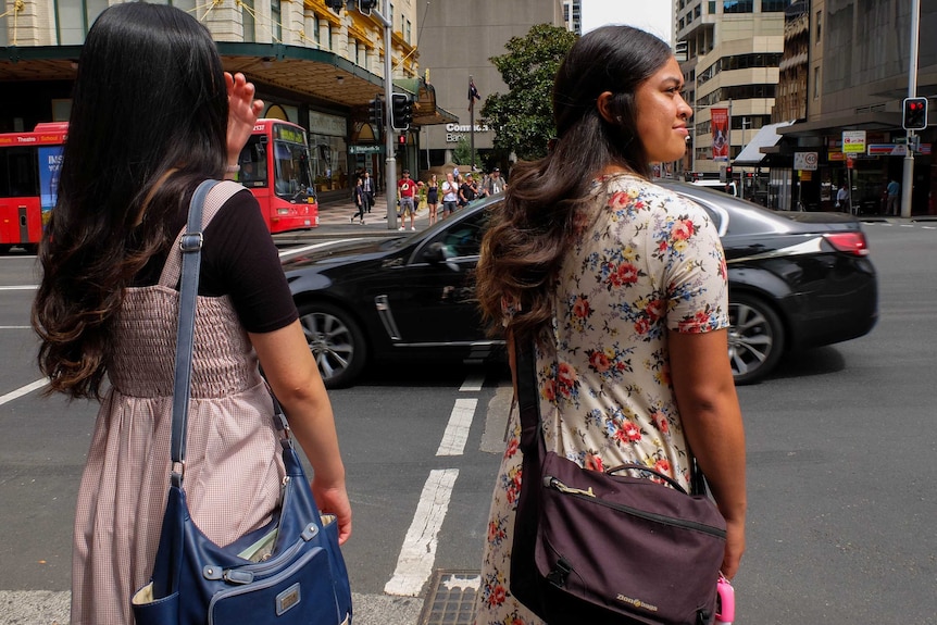 Mormon Sisters standing at traffic lights in Sydney CBD.