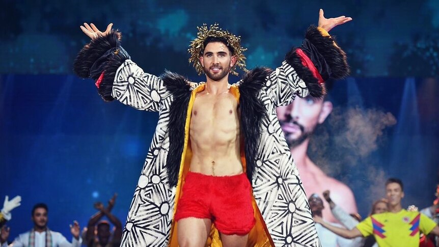 A man on the stage of Mr World in what he believes is 'his national costume'.