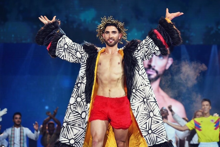 A man on the stage of Mr World in what he believes is 'his national costume'.