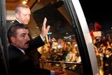 Tayyip Erdogan waves to supporters after arriving in Istanbul.