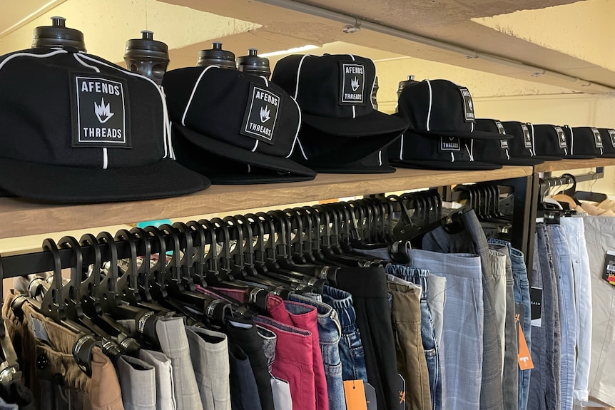 Black baseball caps on shelf