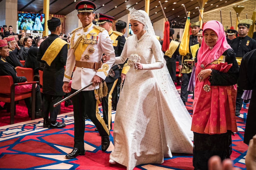 A couple walks down the aisle at their royal wedding. 