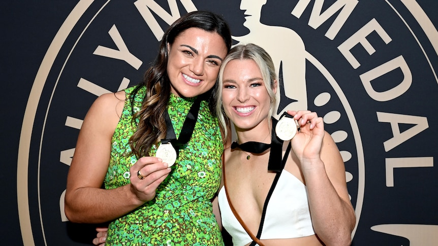 NRLW players Millie Boyle and Emma Tonegato show off their Dally M Medals.