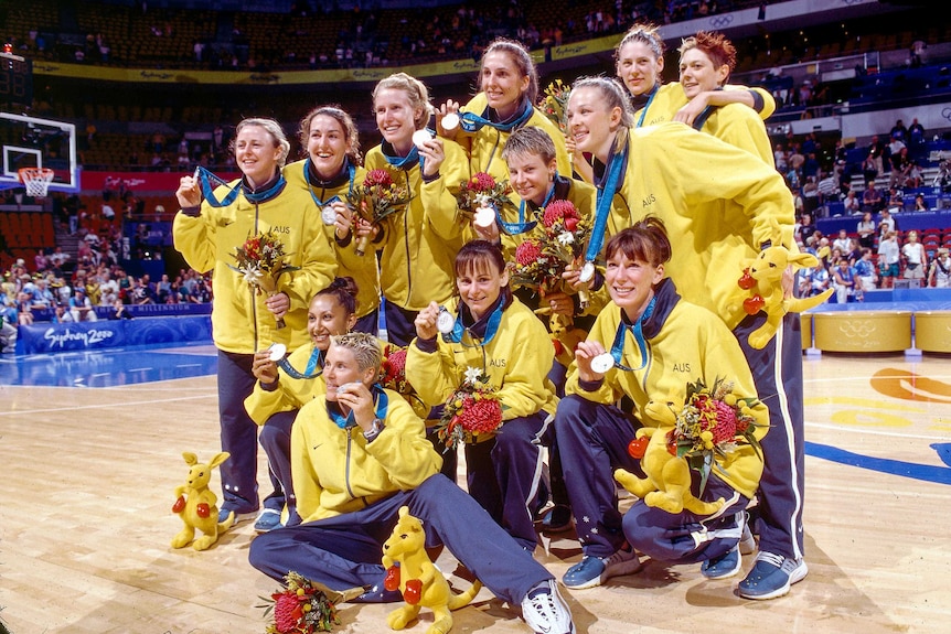 The Australian women's Olympic basketball team holding up their silver medals.