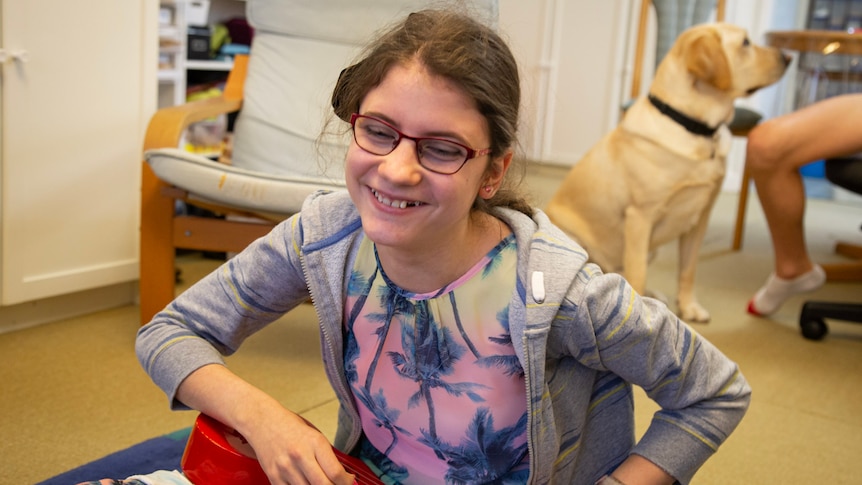 a young girl wearing glasses and smiling