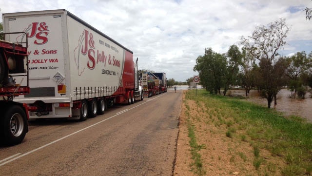 Stranded trucks lined up on Great Northern Highway due to floods