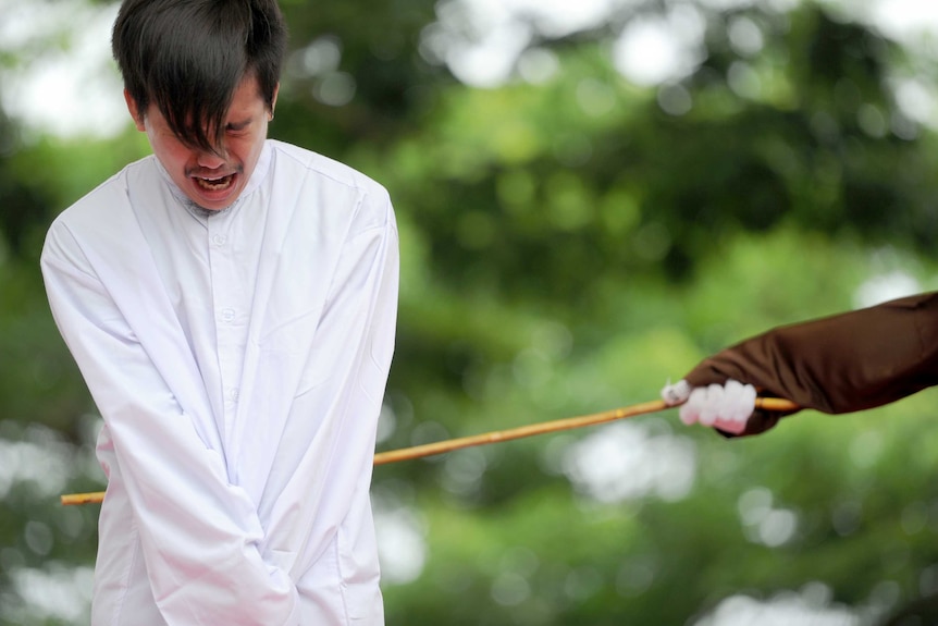 An Indonesian man is publicly caned