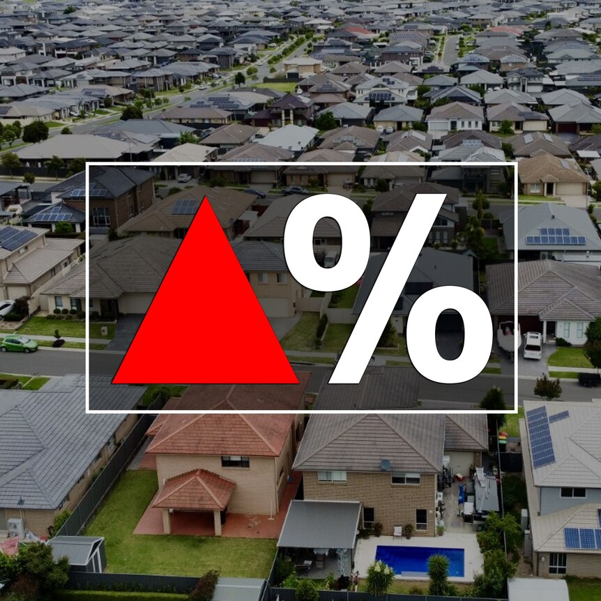 A red up arrow next to a percentage sign on top of an aerial view of dozens of houses.