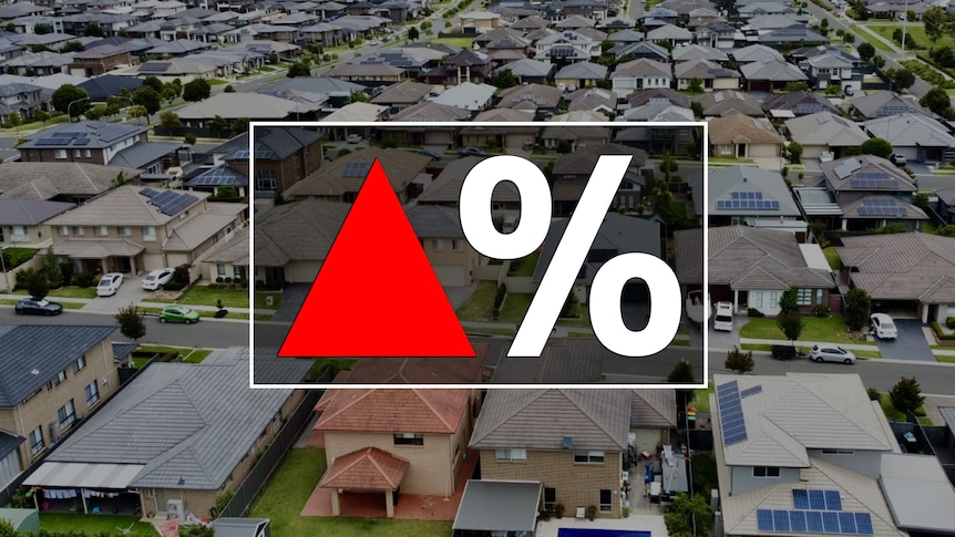 A red up arrow next to a percentage sign on top of an aerial view of dozens of houses.