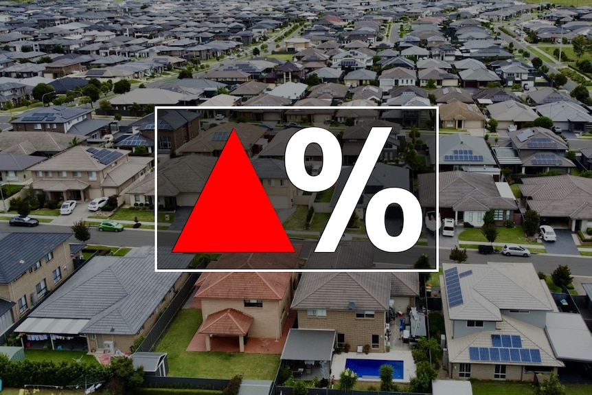 A red up arrow next to a percentage sign on top of an aerial view of dozens of houses.