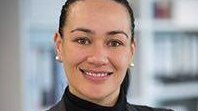 A headshot of a woman smiling