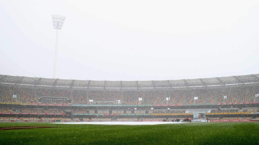 Heavy rain falls during day two of the first Test between Australia and South Africa at the Gabba.