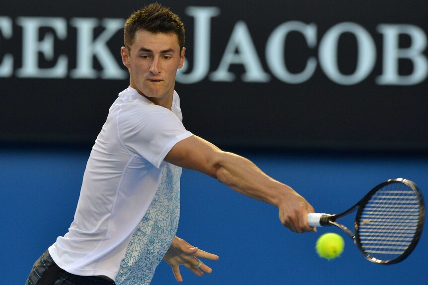 Tomic reaches for a backhand