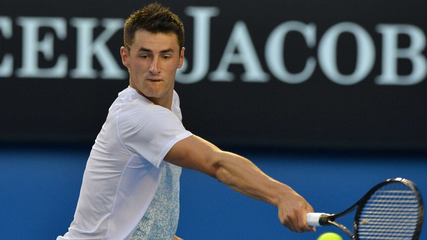 Tomic reaches for a backhand