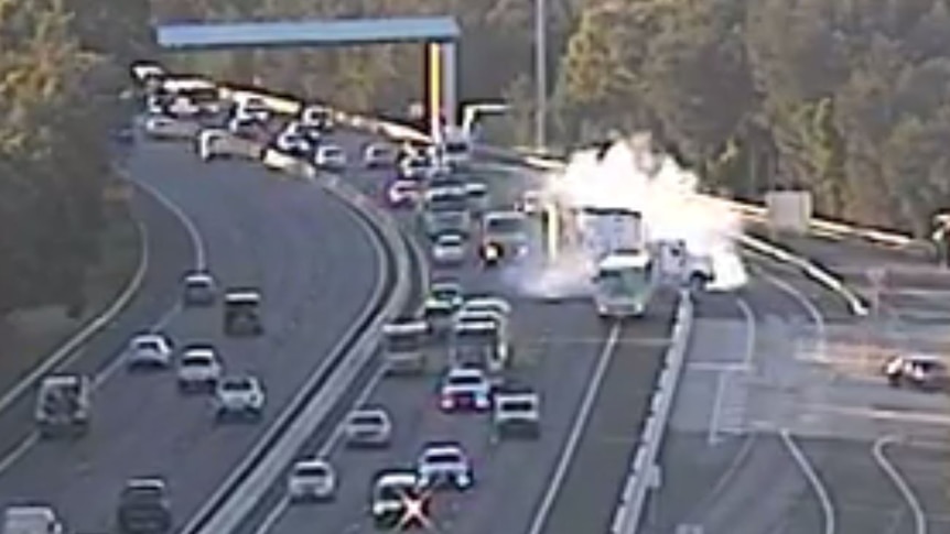 Screen grab of a smoking truck on the highway.