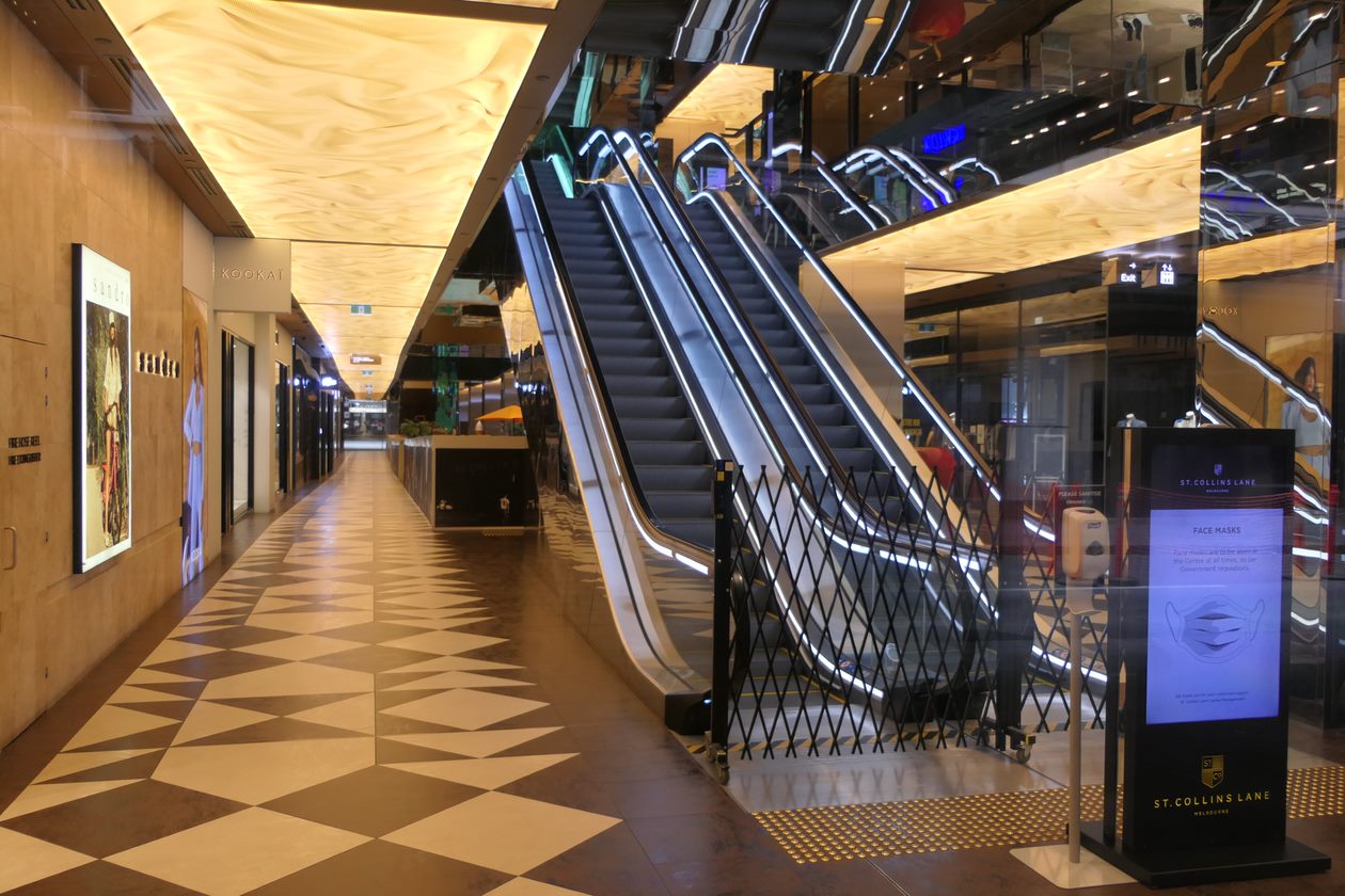 The interior of a shopping centre with two escalators blocked off.