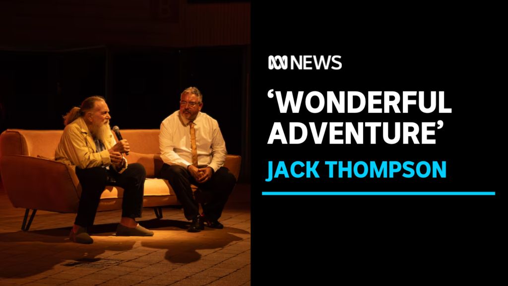 'Wonderful Adventure', Jack Thompson: Two men sitting on a couch on stage. One speaks into a microphone.