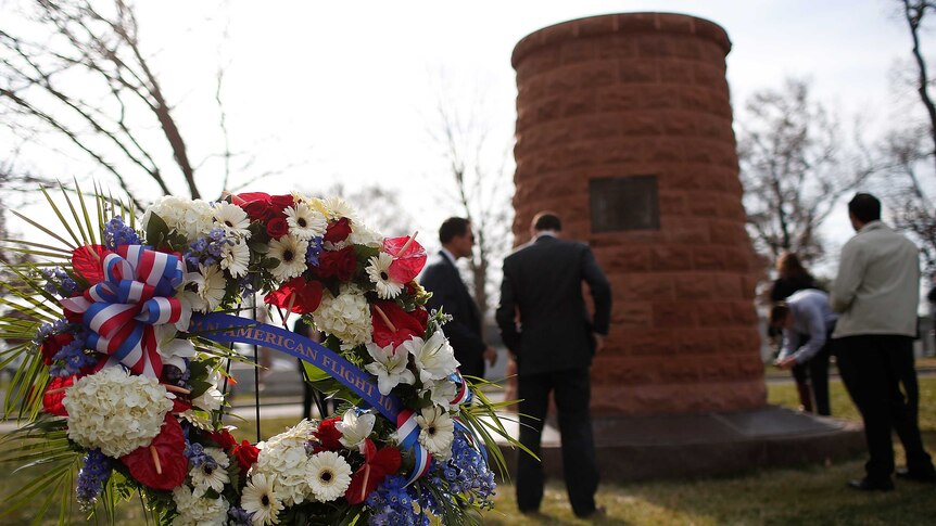 Family members surround a cairn dedicated to those who died on Pan Am Flight 103.