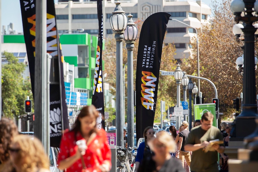 Exterior street scene with people and festival flags