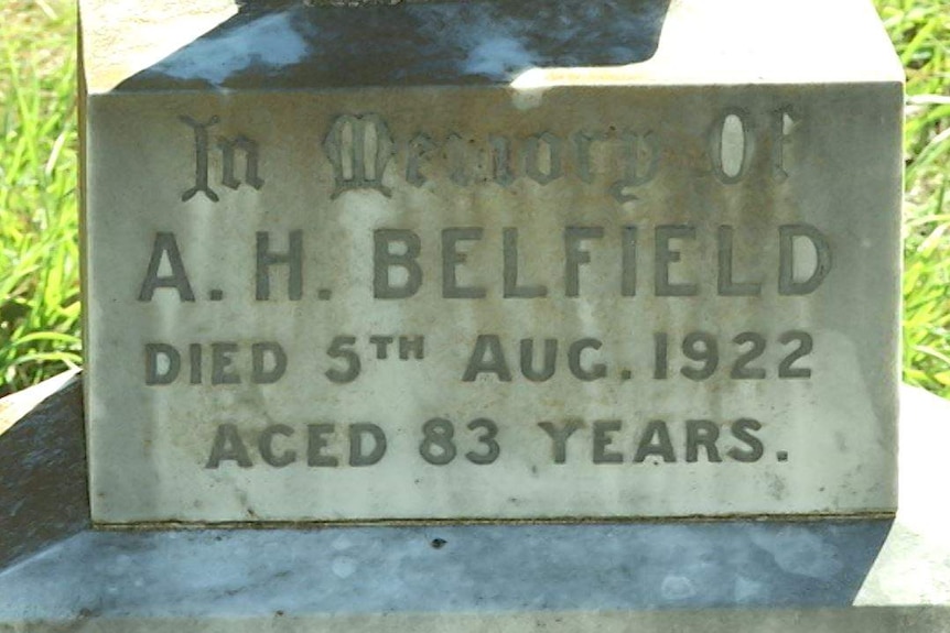 A close-up of a headstone on a gravesite.